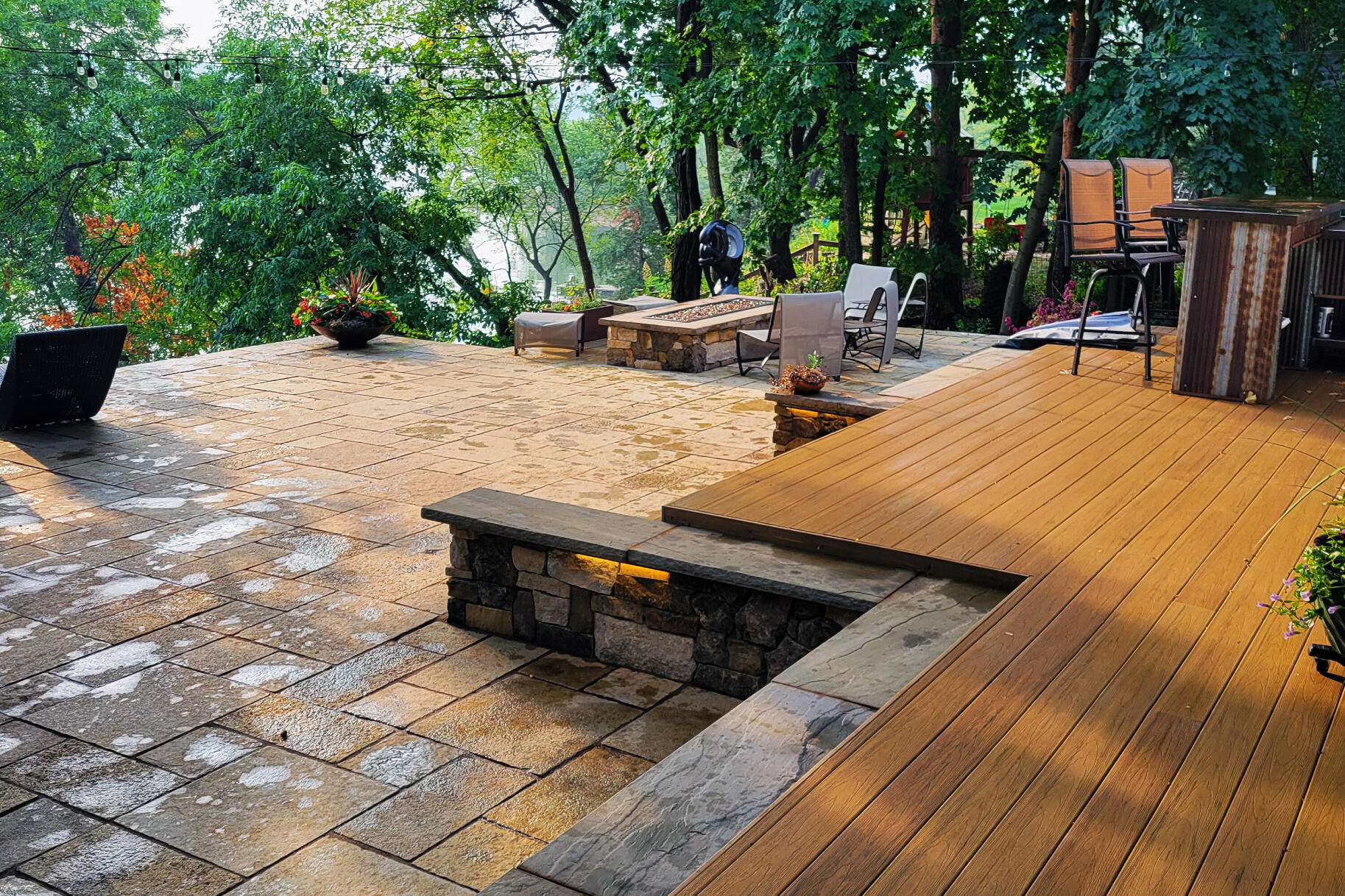 Outdoor wood deck with paver patio overlooking rivers bluffs