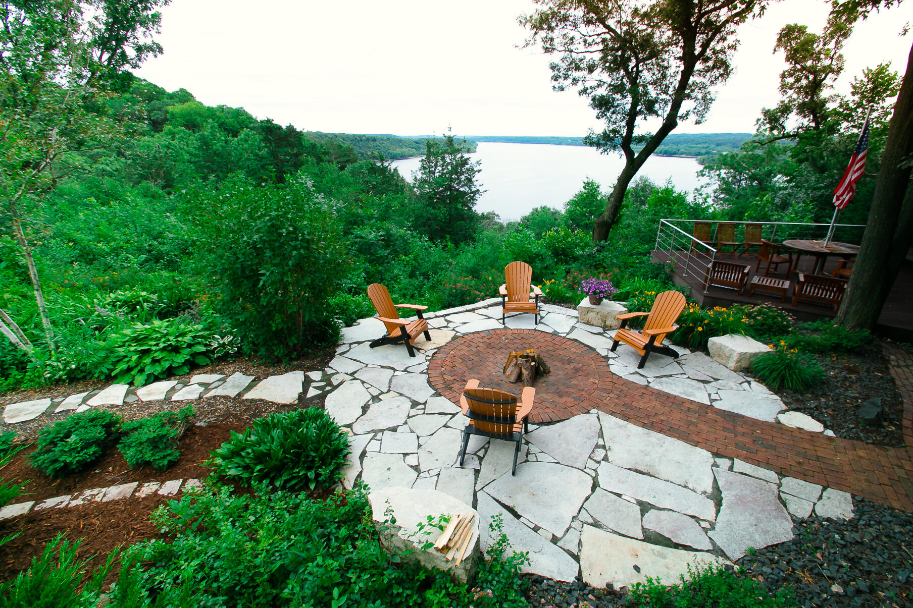 stone work patio with brick firepit lakeside